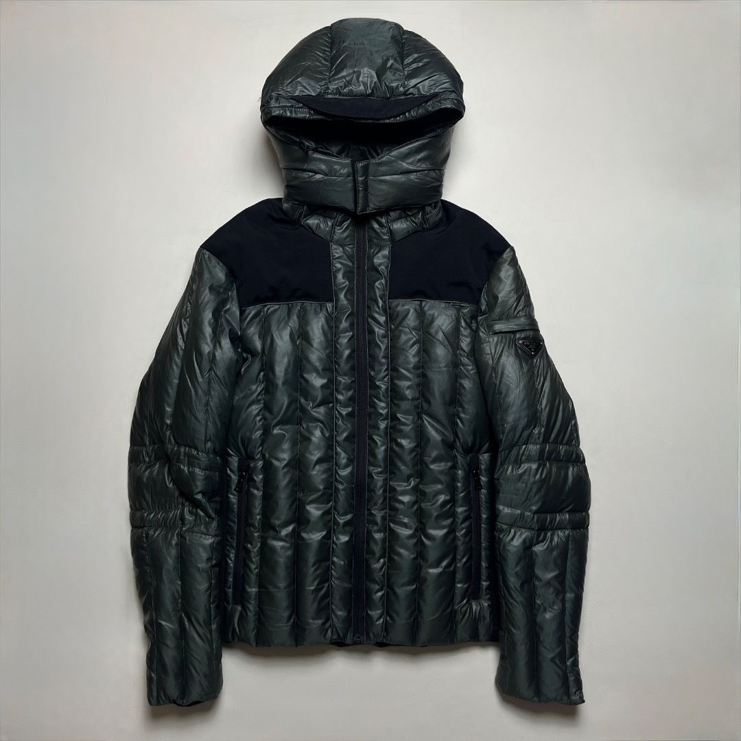 Prada Art SGH384 Puffer Down Jacket (Category: Coats, Jackets and Outerwear) located in Caloocan City. Submitted by achilles_grails (Listing ID 1471079290, Image 1). Description: - Authentic Prada Down Jacket (Art SGH384) - Dark green resin-coated nylon PU outer shell with contrasting black shoulder panels - 100% down and white eiderdown filling for ultimate warmth - Features an attached hood and full front zip closure - Iconic Prada metal triang