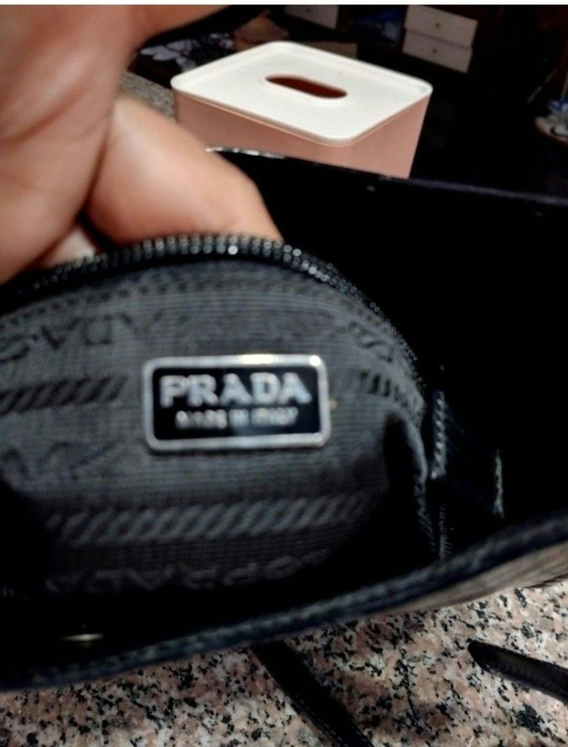Prada Black Leather Studded Shoulder Bag (Category: Luxury Bags & Wallets) located in Lapu Lapu. Submitted by margaux099 (Listing ID 1471061986, Image 3). Description: - 100% Authentic Prada shoulder bag in classic black leather - Chic silver stud detailing along the edges and strap - Embossed Prada logo on the front - Secure zip top closure - Interior lined with signature Prada fabric - Includes an interior zippered pocket with metal tag and aut
