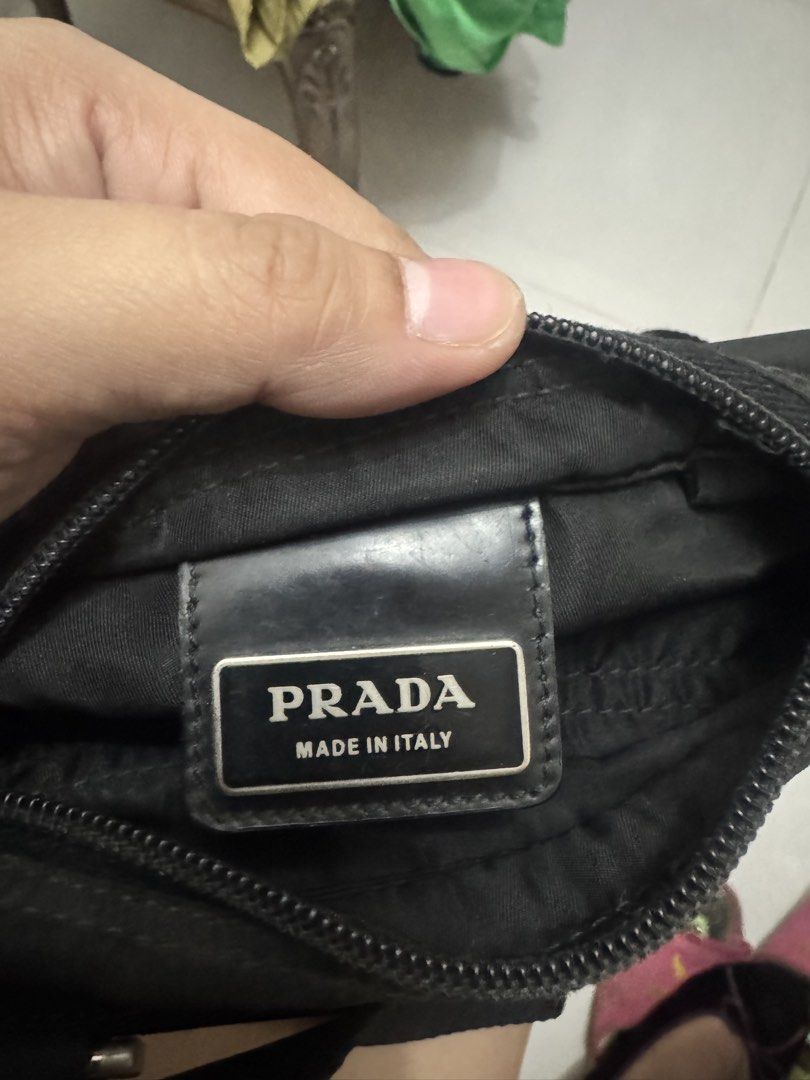 Prada Black Nylon Crossbody Bag (Category: Luxury Bags & Wallets) located in Koronadal. Submitted by milagraciaukayukay123_. (Listing ID 1471097473, Image 3). Description: - Authentic Prada crossbody bag in classic black nylon - Adjustable shoulder strap for comfortable daily wear - Secure front zip pocket with sleek silver-tone hardware - Features the iconic Prada enamel triangle logo on the front - Spacious interior with 'Made in Italy' plaque 