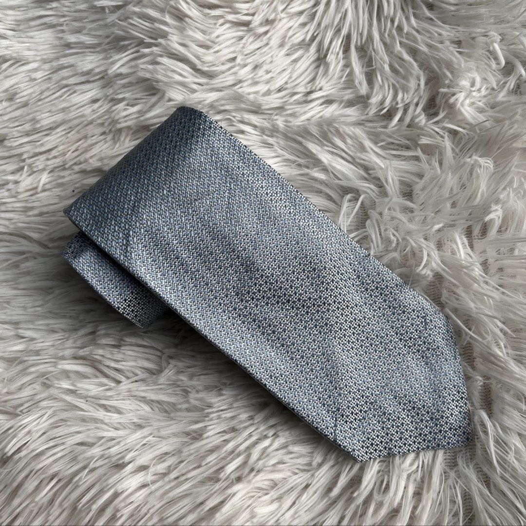 Prada Blue Textured Silk Tie (Category: Ties) located in Cuyapo. Submitted by Ashtyn.Pre.Loved (Listing ID 1471019347, Image 1). Description: - Brand: Prada - Material: Premium silk - Color/Pattern: Textured blue weave - Width: Standard (approx. 3 inches across the blade) - Details: Branded label on back keeper loop - Condition: Clean and ready to wear - Perfect for: Work, interviews, weddings, or formal events.