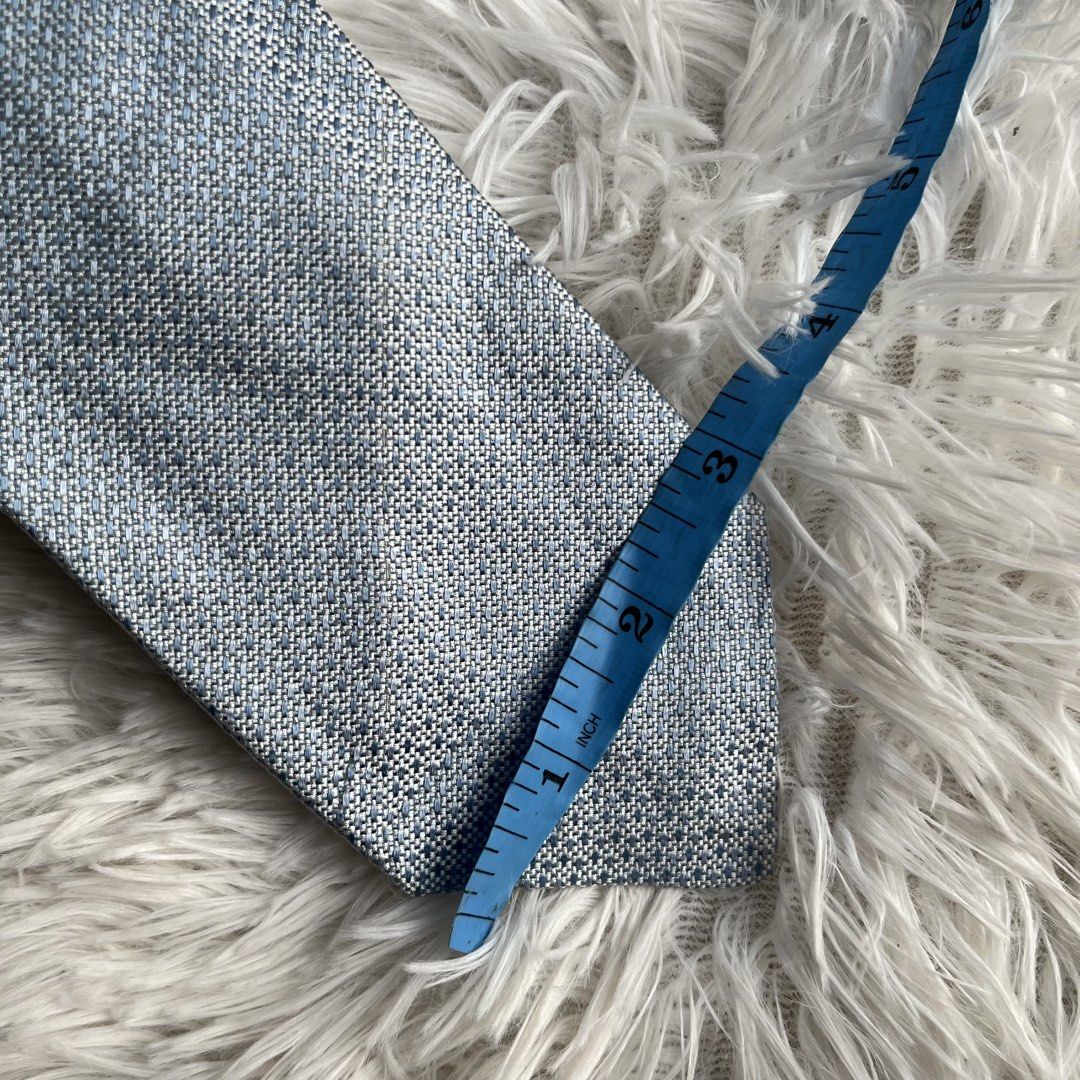 Prada Blue Textured Silk Tie (Category: Ties) located in Cuyapo. Submitted by Ashtyn.Pre.Loved (Listing ID 1471019347, Image 3). Description: - Brand: Prada - Material: Premium silk - Color/Pattern: Textured blue weave - Width: Standard (approx. 3 inches across the blade) - Details: Branded label on back keeper loop - Condition: Clean and ready to wear - Perfect for: Work, interviews, weddings, or formal events.