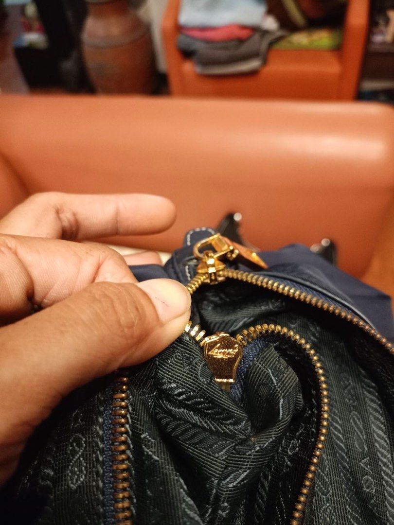Prada Nylon Flap Top Handle Bag Navy Blue (Category: Luxury Bags & Wallets) located in Quezon City. Submitted by yunajohan24 (Listing ID 1470964041, Image 2). Description: - Authentic Prada navy blue nylon handbag - Premium Saffiano leather trim and gold-tone hardware - Iconic enamel triangle logo on the front flap - Double top handles for comfortable carrying - Secure top zip closure - Signature Prada jacquard lining with interior gold-toned Pra