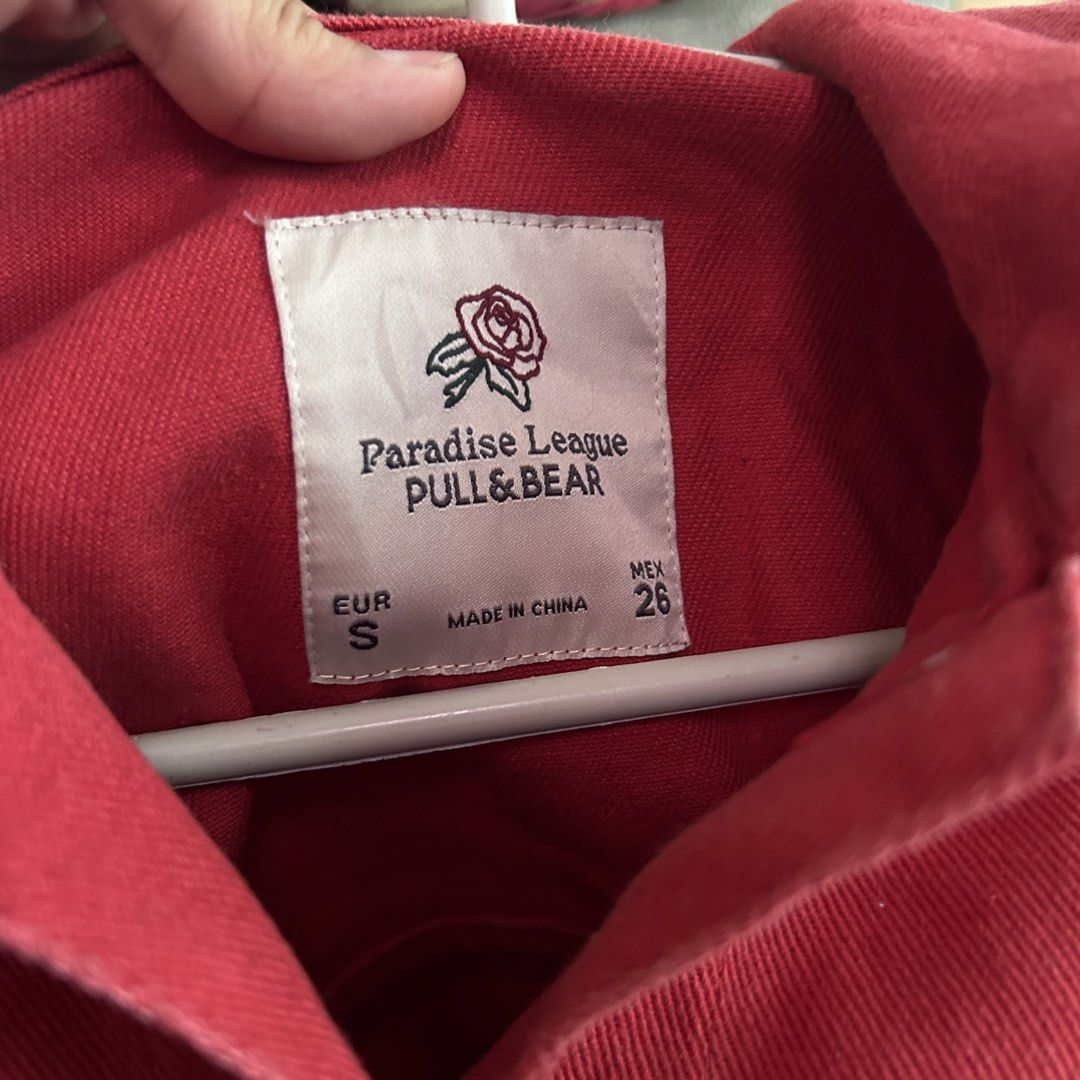 Pull & Bear Paradise League Red Denim Jacket (Category: Coats, Jackets and Outerwear) located in Manila. Submitted by tasha_11 (Listing ID 1471058992, Image 3). Description: - Brand: Pull & Bear (Paradise League collection) - Color: Vibrant Red - Size: S (EUR S, MEX 26) - Features: Classic collar, button-up front, two chest pockets, trendy raw hem detail - Condition: Great staple outerwear piece - Made in China.
