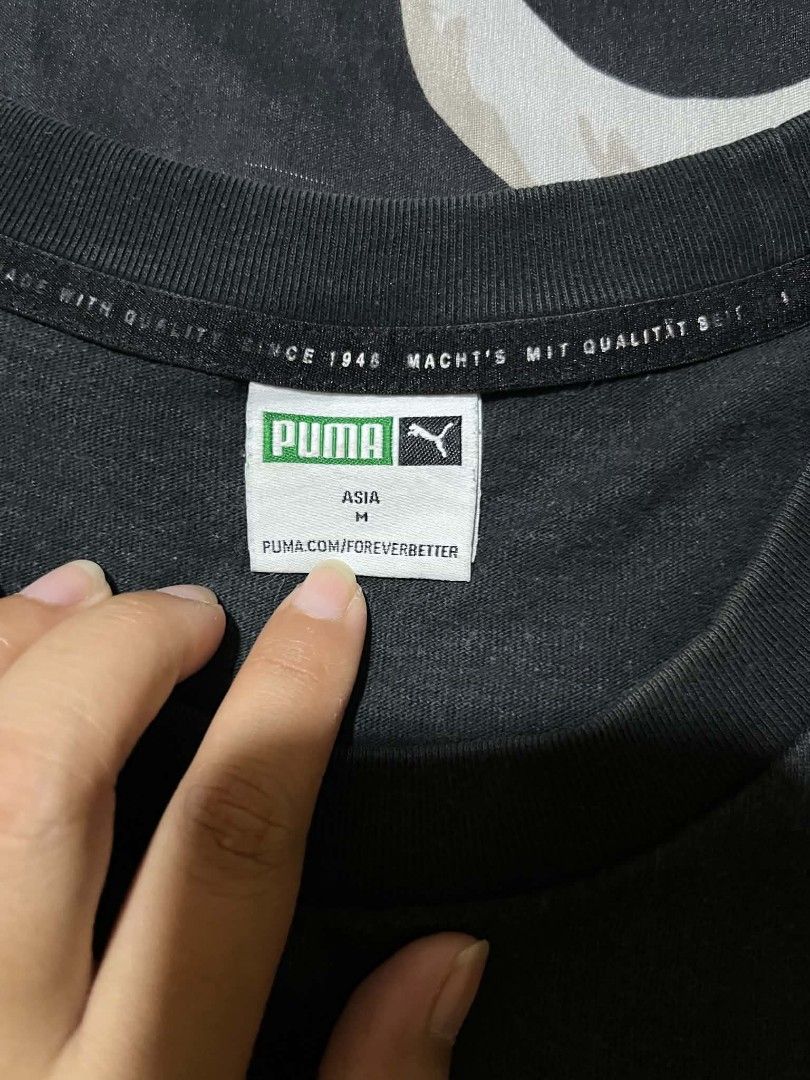 Puma Black T-shirt Size M (Category: Formal Shirts) located in Taguig. Submitted by 22nd_street_thrift (Listing ID 1470942190, Image 3). Description: - Color: Black - Brand: Puma - Size: Asia M (Standard Fit) - Style Number: 533100-01 - Design: Short sleeves, crew neck, small centered white Puma logo on chest - Details: Inside collar tape features heritage text "Machts Mit Qualitat Seit 1948" - Origin: Made in China - Condition: Brand new / Excel