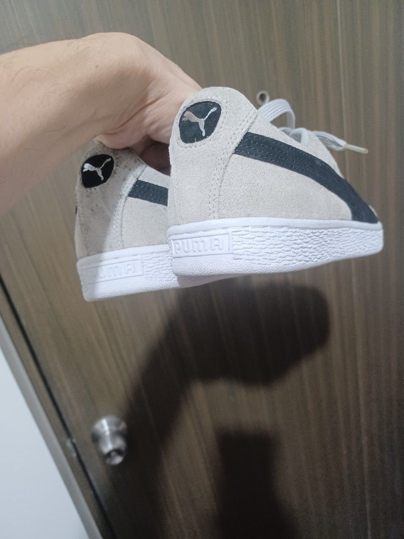 Puma Suede Classic Grey Black Sneakers (Category: Sneakers) located in Mandaluyong City. Submitted by usamenfashionhaul (Listing ID 1471113724, Image 3). Description: - Brand/Model: Puma Suede Sneakers - Color: Grey and black with white rubber soles and matching grey laces - Design: Classic low-top with iconic Puma branding on the side and heel tab - Style: Comfortable everyday streetwear - Condition: Minor signs of wear on the suede upper.