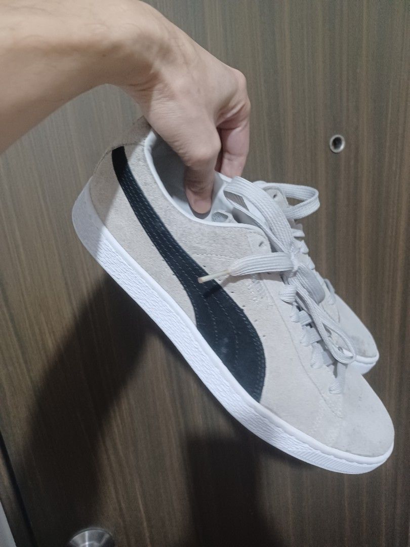 Puma Suede Classic Grey Black Sneakers (Category: Sneakers) located in Mandaluyong City. Submitted by usamenfashionhaul (Listing ID 1471113724, Image 1). Description: - Brand/Model: Puma Suede Sneakers - Color: Grey and black with white rubber soles and matching grey laces - Design: Classic low-top with iconic Puma branding on the side and heel tab - Style: Comfortable everyday streetwear - Condition: Minor signs of wear on the suede upper.