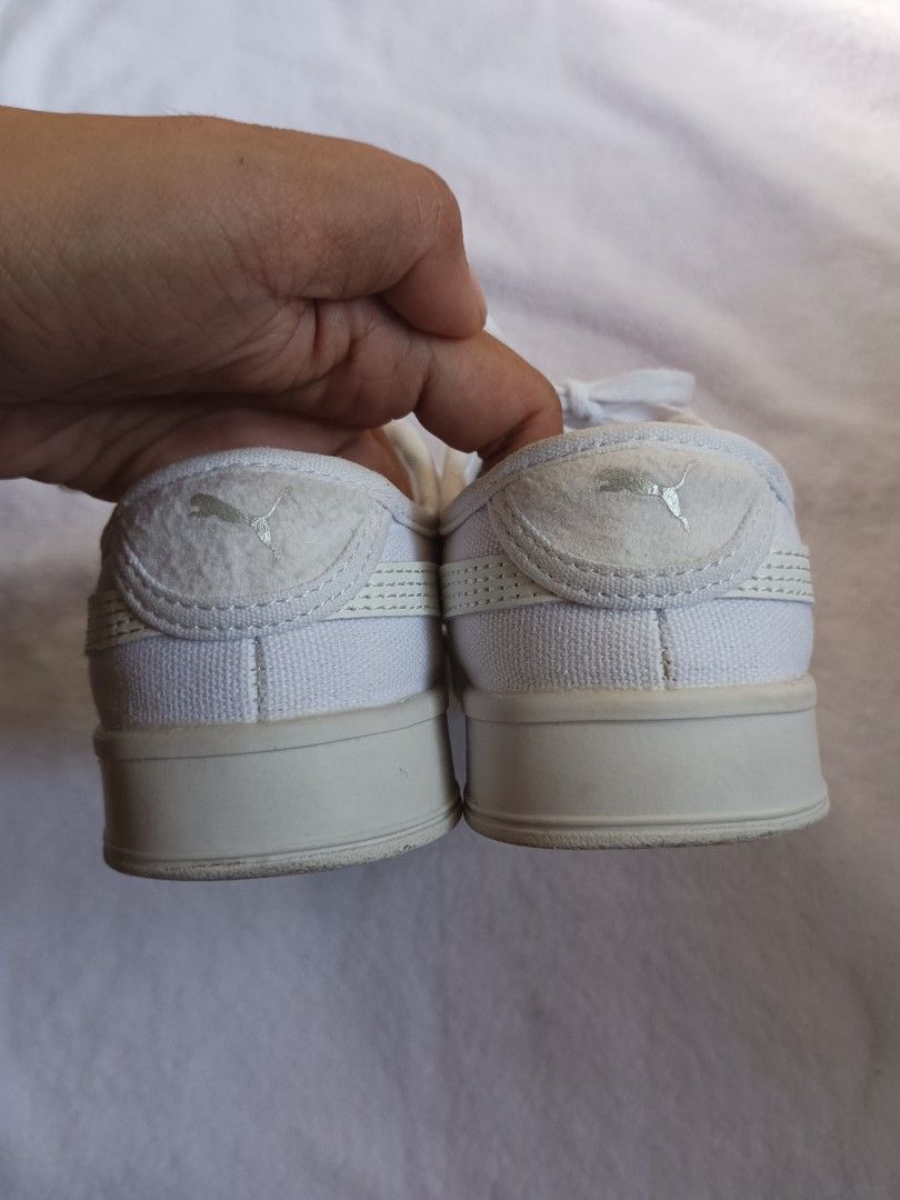 Puma White Canvas Platform Sneakers (Category: Sneakers) located in Malabon City. Submitted by mslalan (Listing ID 1470973813, Image 3). Description: - Brand: Puma - Style: White canvas low-top sneakers with thick platform soles - Size: US 6 / UK 3.5 / EU 36 - Details: Textured toe cap, heel counter, and stylish silver Puma branding - Condition: Clean canvas uppers with light wear on the soles underneath, ready to wear.