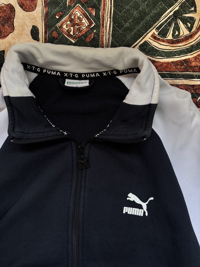 Puma XTG track Jacket (Category: Coats, Jackets and Outerwear) located in Baguio. Submitted by zojythriftph (Listing ID 1471025983, Image 2). Description: 26.5 × W20- Large Condition: Good used condition Flaws: Minor fraying on sleeve cuffs and small holes. Please manage expectations and check photos for details before buying. Color Rate- 9/10 Mine:290 📌 Disclaimer: For reselling purposes only. All branded items are thrifted/preloved. Wear more.