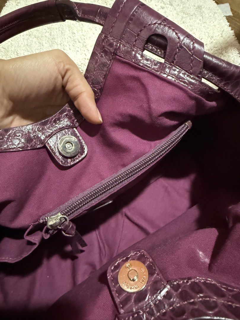 Purple Crocodile Embossed Leather Handbag (Category: Luxury Bags & Wallets) located in Pasig City. Submitted by patrissia1129 (Listing ID 1470977798, Image 3). Description: - Color/Texture: Rich purple with all-over faux crocodile finish - Closure: Secure magnetic snap - Interior: Matching purple fabric lining with a zipped compartment for small items - Capacity: Deep interior that easily fits everyday essentials - Design: Double handles with stu