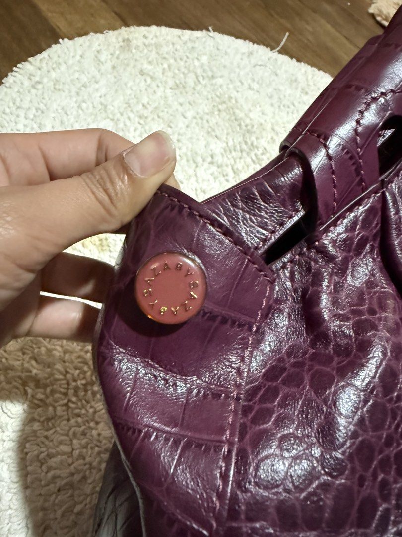 Purple Crocodile Embossed Leather Handbag (Category: Luxury Bags & Wallets) located in Pasig City. Submitted by patrissia1129 (Listing ID 1470977798, Image 2). Description: - Color/Texture: Rich purple with all-over faux crocodile finish - Closure: Secure magnetic snap - Interior: Matching purple fabric lining with a zipped compartment for small items - Capacity: Deep interior that easily fits everyday essentials - Design: Double handles with stu