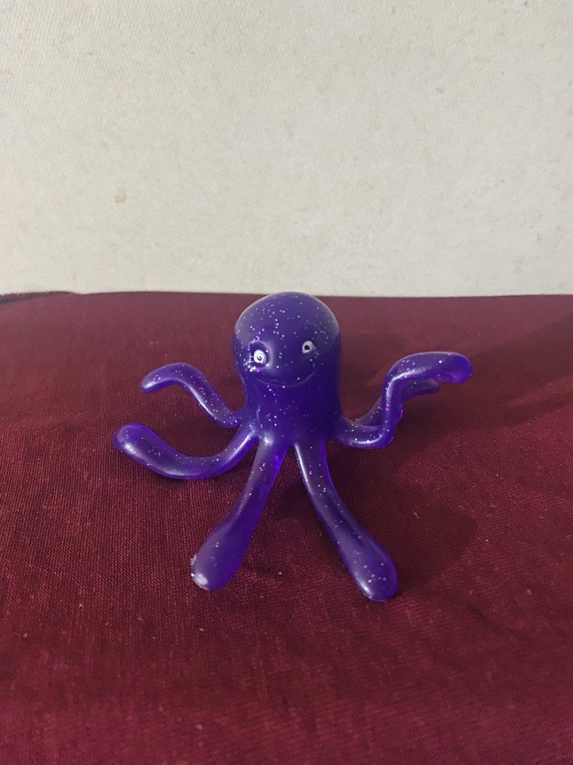 Purple Glitter Octopus Toy Figure (Category: Figurines & Statues) located in Manila. Submitted by secretjoy.609 (Listing ID 1470992377, Image 1). Description: - Purple sparkly octopus toy figurine - Made of translucent plastic filled with fine glitter specks - Features small printed eyes and a sweet smile - Multiple curved arms posed in different directions - Great as a cute desk buddy or a fun toy for kids.