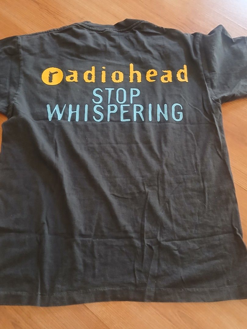 Radiohead Stop Whispering T-Shirt (Category: Tshirts & Polo Shirts ) located in Pasig City. Submitted by jmluna_iii45224 (Listing ID 1470988738, Image 2). Description: - Item: Vintage Radiohead Band T-Shirt - Color: Dark Grey - Material: 100% Cotton (super soft, broken-in feel) - Front Design: Suit illustrations with 'STOP WHISPERING START SHOUTING' text - Back Design: Vertical 'radiohead' and 'STOP WHISPERING' in yellow and blue print - Fit: Sho