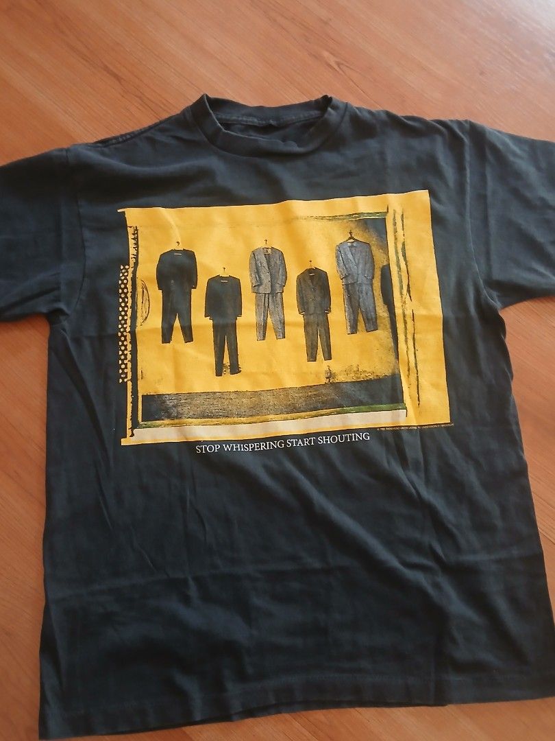 Radiohead Stop Whispering T-Shirt (Category: Tshirts & Polo Shirts ) located in Pasig City. Submitted by jmluna_iii45224 (Listing ID 1470988738, Image 1). Description: - Item: Vintage Radiohead Band T-Shirt - Color: Dark Grey - Material: 100% Cotton (super soft, broken-in feel) - Front Design: Suit illustrations with 'STOP WHISPERING START SHOUTING' text - Back Design: Vertical 'radiohead' and 'STOP WHISPERING' in yellow and blue print - Fit: Sho
