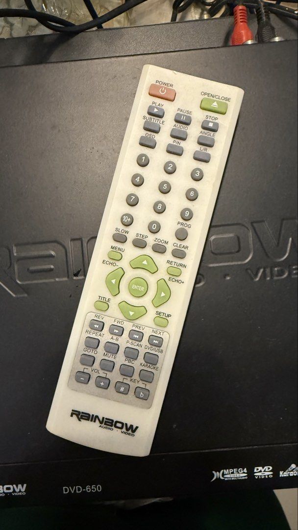 Rainbow Audio Video DVD-650 Player with Remote (Category: Blu-Ray & Media Players) located in Muntinlupa City. Submitted by dnqdp (Listing ID 1471025114, Image 2). Description: - Model: Rainbow Audio Video DVD Player (DVD-650) - Color: Black casing with engraved top brand logo - Features: Supports MPEG4, DVD, HDCD, MP3, and Karaoke - Condition: Powers on and works great (minor surface dust from storage) - Included: Original matching white remote 