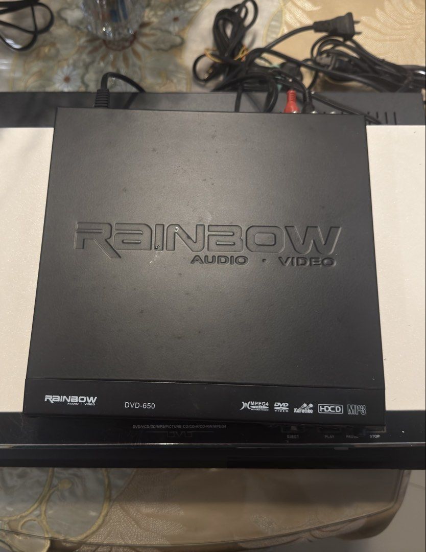 Rainbow Audio Video DVD-650 Player with Remote (Category: Blu-Ray & Media Players) located in Muntinlupa City. Submitted by dnqdp (Listing ID 1471025114, Image 1). Description: - Model: Rainbow Audio Video DVD Player (DVD-650) - Color: Black casing with engraved top brand logo - Features: Supports MPEG4, DVD, HDCD, MP3, and Karaoke - Condition: Powers on and works great (minor surface dust from storage) - Included: Original matching white remote 