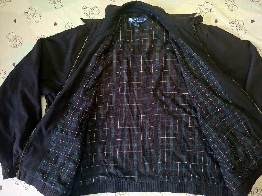 Ralph Lauren Black Bi-Swing Harrington Jacket (Category: Coats, Jackets and Outerwear) located in Rizal. Submitted by carou66859 (Listing ID 1470992139, Image 2). Description: The image shows a black Polo Ralph Lauren Harrington zip-up jacket featuring a small embroidered Polo Pony logo on the chest and a plaid-lined collar.Size 26 inches width and 27 inches length.The estimated retail price for a new Polo Ralph Lauren Bi-Swing Windbreaker / Harr