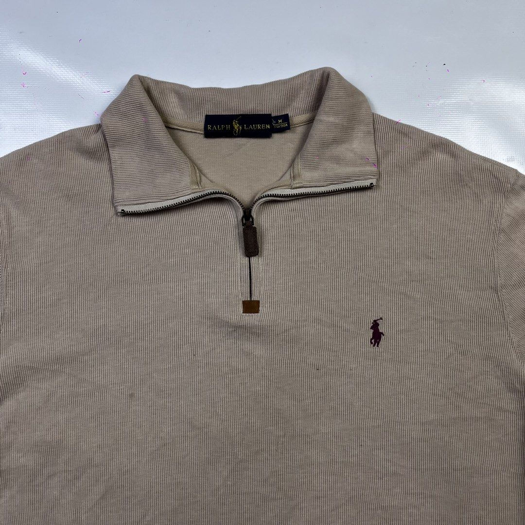Ralph Lauren Tan Quarter Zip Pullover Sweater (Category: Coats, Jackets and Outerwear) located in Lucena. Submitted by nifty_finds (Listing ID 1470976419, Image 3). Description: - Brand: Ralph Lauren - Style: Quarter-zip pullover with high collar and leather zipper pull - Color/Fabric: Tan ribbed fabric with brown embroidered chest logo - Size: Medium - Yellow Stains .