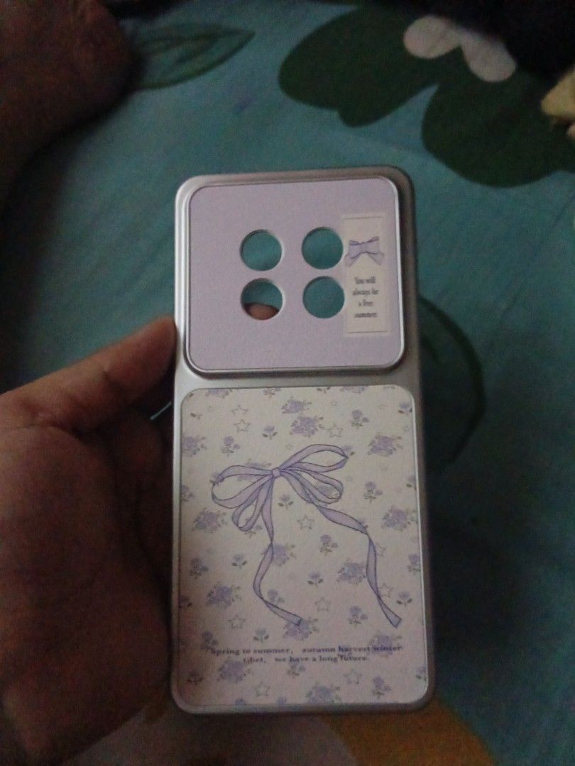 Realme 13 Plus 5G (Category: Cases & Sleeves) located in Manila. Submitted by jmaeee07 (Listing ID 1471056477, Image 2). Description: - Compatibility: Realme 13 Plus 5G - Design: Cute purple bow with floral print and leather-like texture - Inclusions: Comes with a matching wrist strap - Condition: Brand new, unused (kakadeliver lang, namali ng order) - Reason for selling: Wrong model ordered.