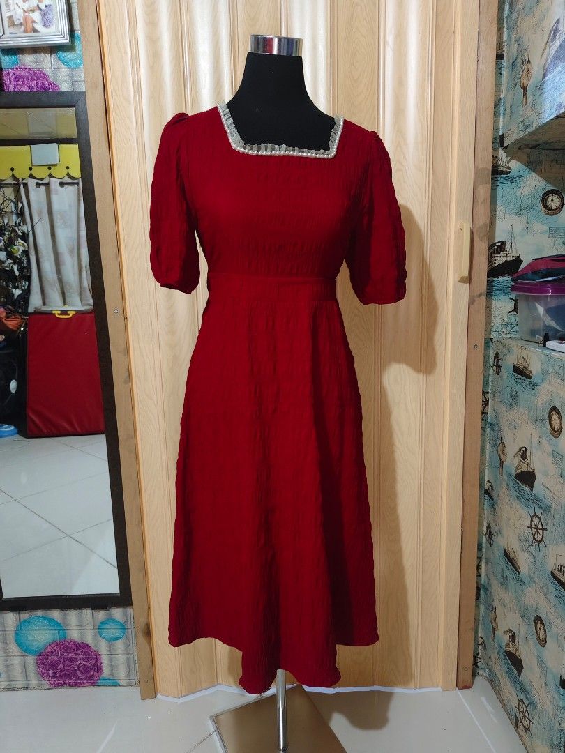 Red Maxi Dress With Pearl Collar (Category: Dresses) located in Manila. Submitted by duffy-080 (Listing ID 1471056546, Image 3). Description: Red midi dress from Xin Fu Shi. Square neckline trimmed with tiny white pearls and ruffled fabric. Short puffed sleeves and smocked textured fabric throughout. Back features a tie-up ribbon closure at the neck. Midi length with a fitted bodice and flared skirt..