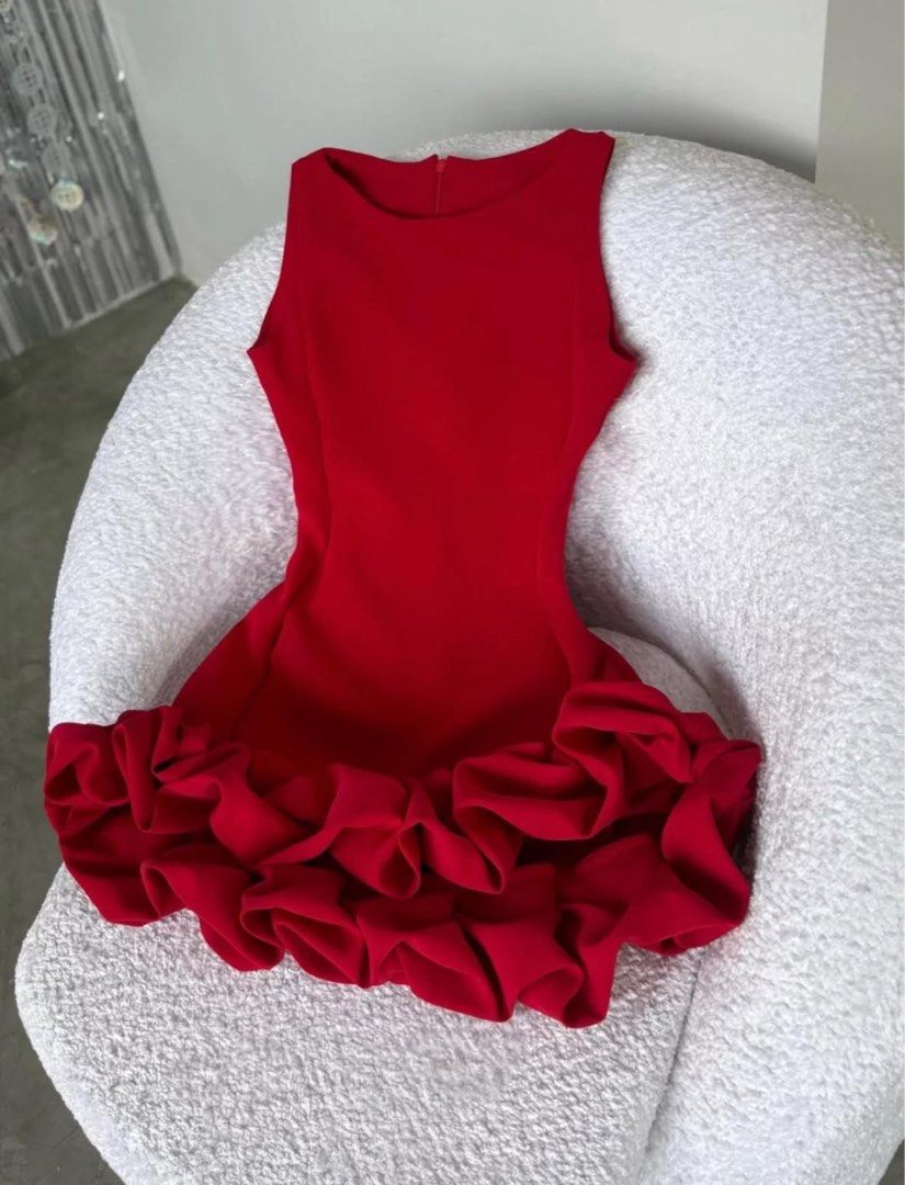 Red mini dress with dramatic ruffle hem (Category: Dresses) located in Manila. Submitted by cielopenaf02780 (Listing ID 1471063430, Image 2). Description: - Color: Vibrant red - Style: Sleeveless mini dress with dramatic voluminous ruffle hem - Fit: Fitted bodice with low scoop back and hidden back zipper closure - Material: Smooth fabric with slight stretch for comfort - Occasion: Perfect for parties, dates, or nights out - Note: Measurements av