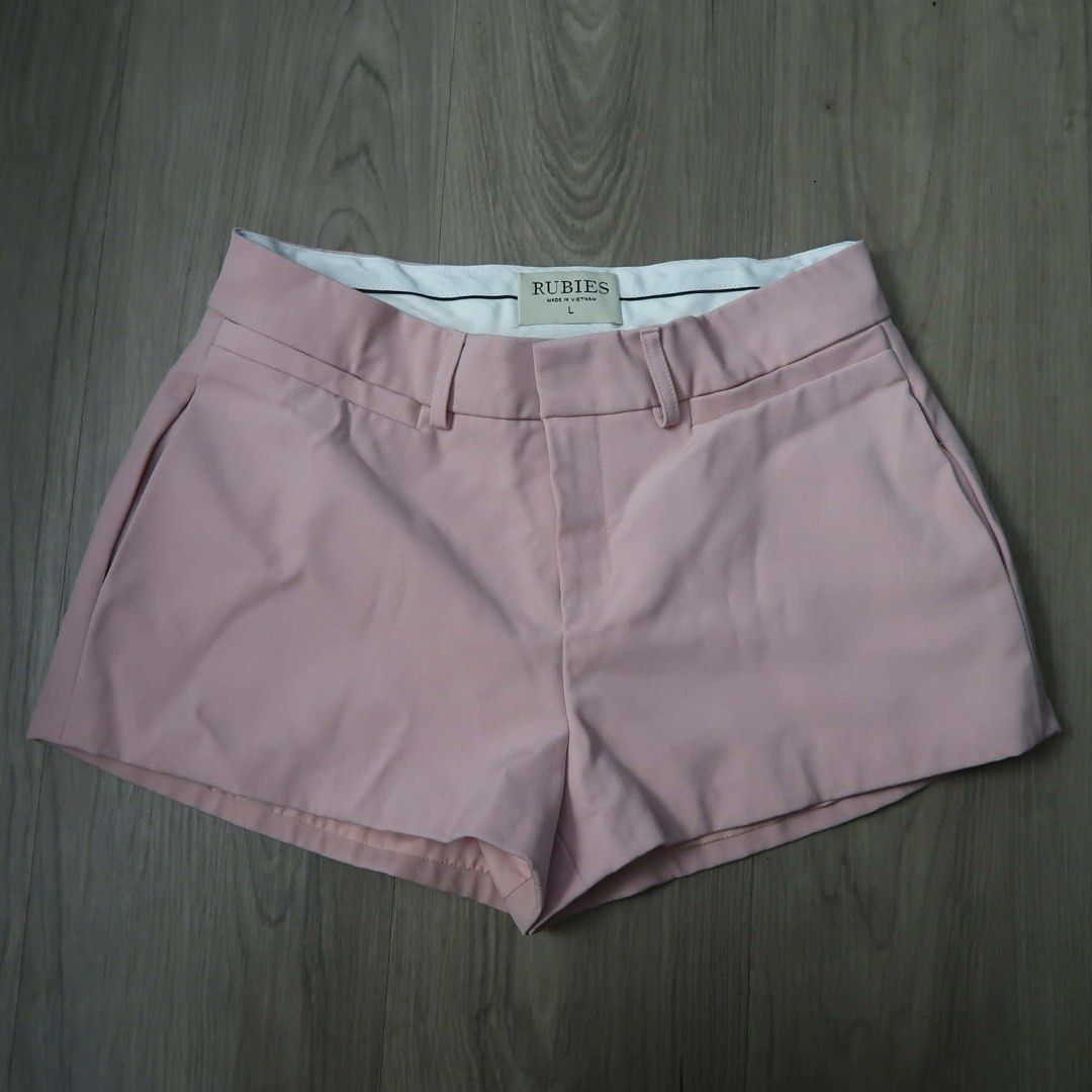 Rubies Pink Tailored Shorts Size L (Category: Shorts) located in Manila. Submitted by mixi_lexi (Listing ID 1471032043, Image 1). Description: - Brand: Rubies - Color: Light Pink - Size: Large (tag inside waistband) - Features: Structured waist with belt loops, front zipper fly, and clean white inner lining - Perfect for effortless, stylish casual outfits.