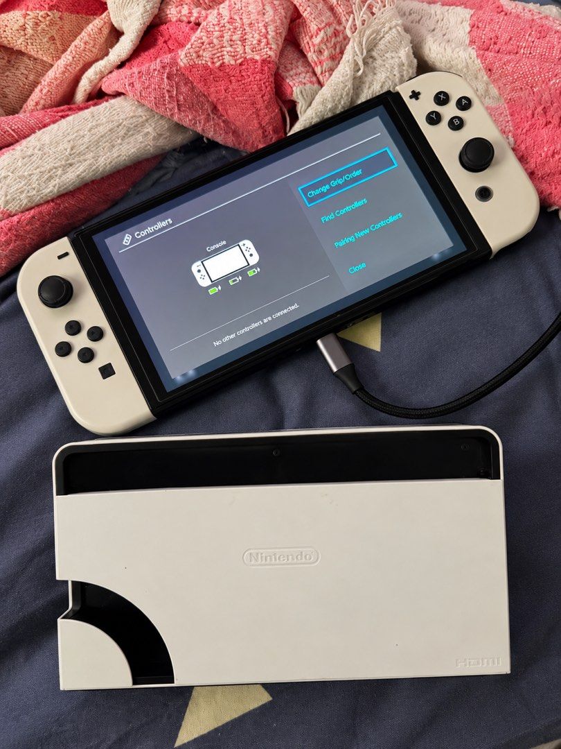 RUSH Nintendo Switch OLED Model White with Dock *Original SRP 20,495* (Category: Nintendo) located in Pasig City. Submitted by noeljr.comia (Listing ID 1470979042, Image 3). Description: - Model: Nintendo Switch OLED (White) - Included: Console, white Joy-Cons, and white charging dock - Condition: Clean unit, fully tested, powers on and connects properly - Serial number: Visible on screen - Status: Ready for gaming - Honest Issue: Left joy-con wo