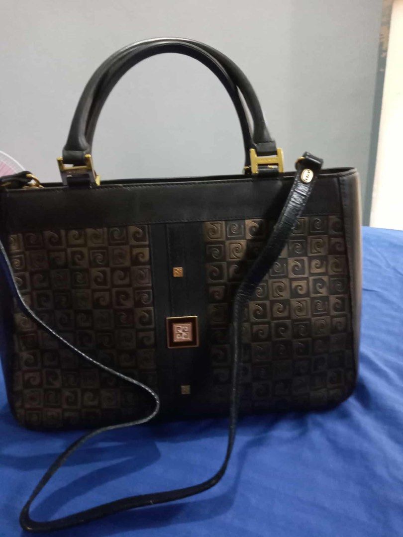 RUSH SALE!! Authentic Pierre Cardin Paris Black Patterned Handbag with Strap (Category: Luxury Bags & Wallets) located in Quezon City. Submitted by unique2shop (Listing ID 1470990411, Image 1). Description: - Brand: Pierre Cardin Paris - Color: Classic black with monogram patterned side panels - Hardware: Gold tone with branded zipper pull - Straps: Includes top carry handles and a detachable shoulder strap - Interior: Branded fabric lining with 