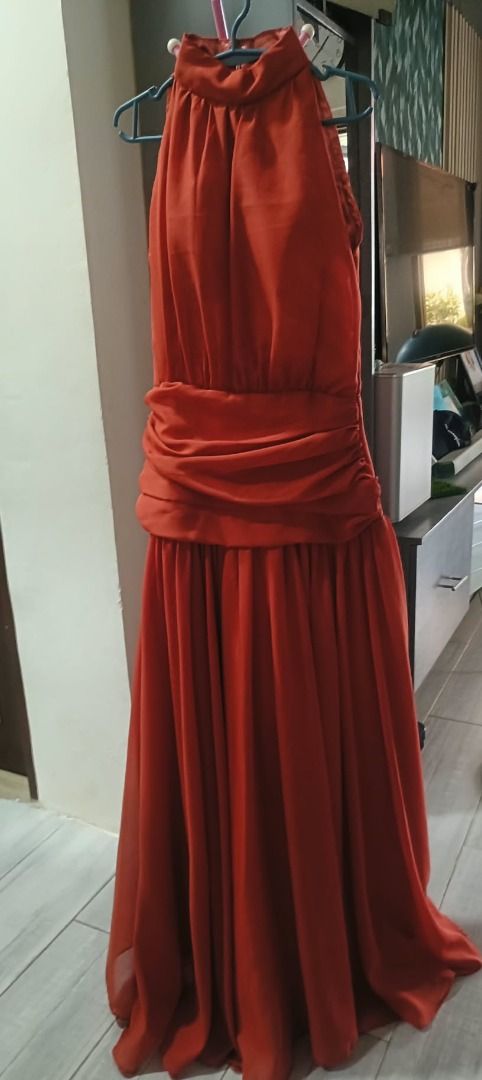 Rust Orange Bridesmaid halter neck dress (Category: Dresses) located in Abucay. Submitted by charkolefishies (Listing ID 1471003071, Image 2). Description: - Color: Rust orange - Style: Halter neck maxi dress with a pleated skirt - Details: Cinched draped waistline - Condition: Worn once, clean, and ready to wear.
