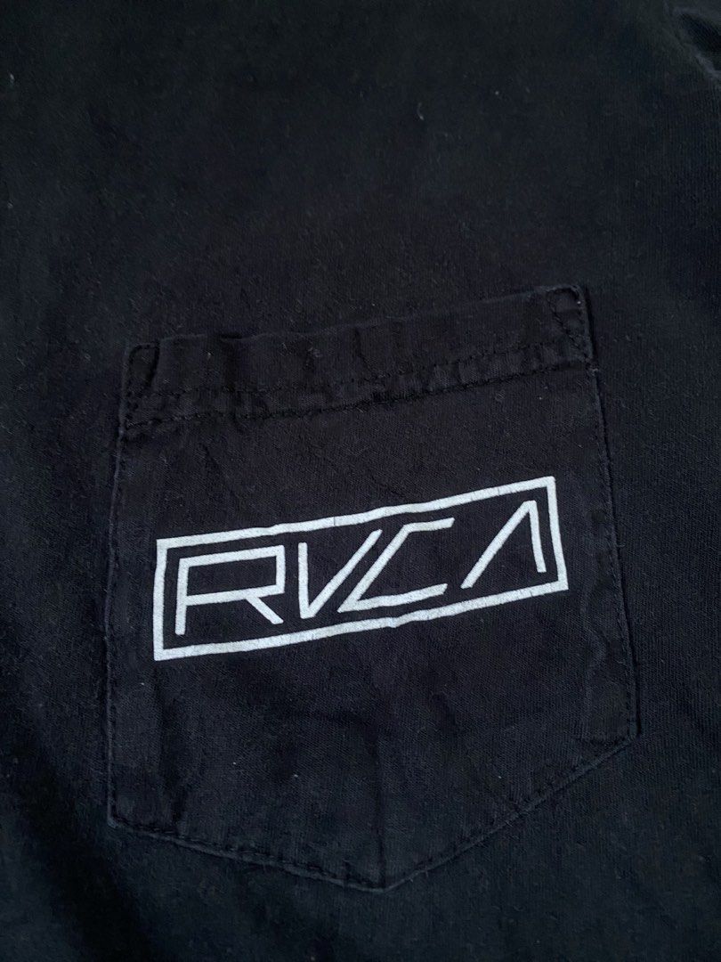 RVCA (Category: Tshirts & Polo Shirts ) located in Cebu City. Submitted by thriftpherskzai (Listing ID 1470978803, Image 3). Description: - Brand: RVCA - Color: Black - Fit: Regular fit with classic crew neck - Details: Left chest pocket with white logo, sleeve graphics, and large back print - Material: 100% comfortable cotton - Perfect for casual everyday streetwear style RVCA SIZE M FIT L 21W x 28L EXCELLENT CRACKS ON SOME PRINT SEE DETAILS.
