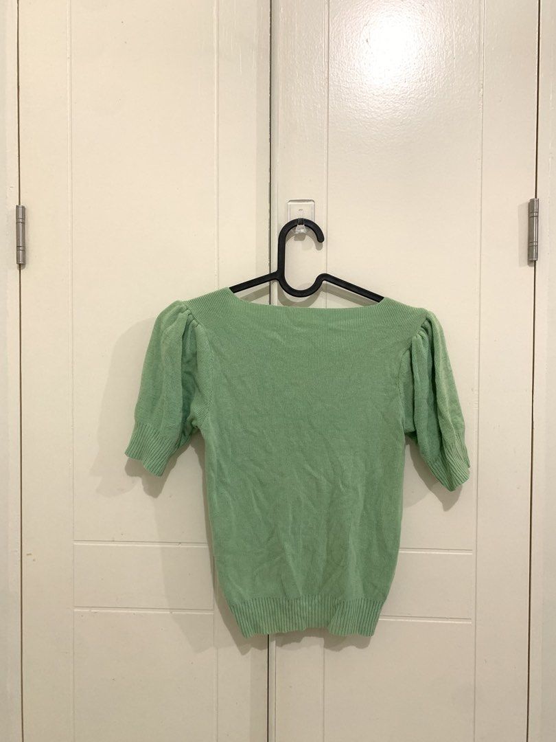 Sage Green Knit Puff Sleeve Ruched Top (Category: Blouses) located in Pasig City. Submitted by lovedbyri (Listing ID 1470953324, Image 3). Description: - Color: Sage green - Style: Fitted knit top with short puff sleeves and square neckline - Details: Ruched front with ribbed texture on collar, cuffs, and hem - Material: Stretchy, super comfortable fabric - Versatility: Great for casual days or paired with high-waisted jeans.