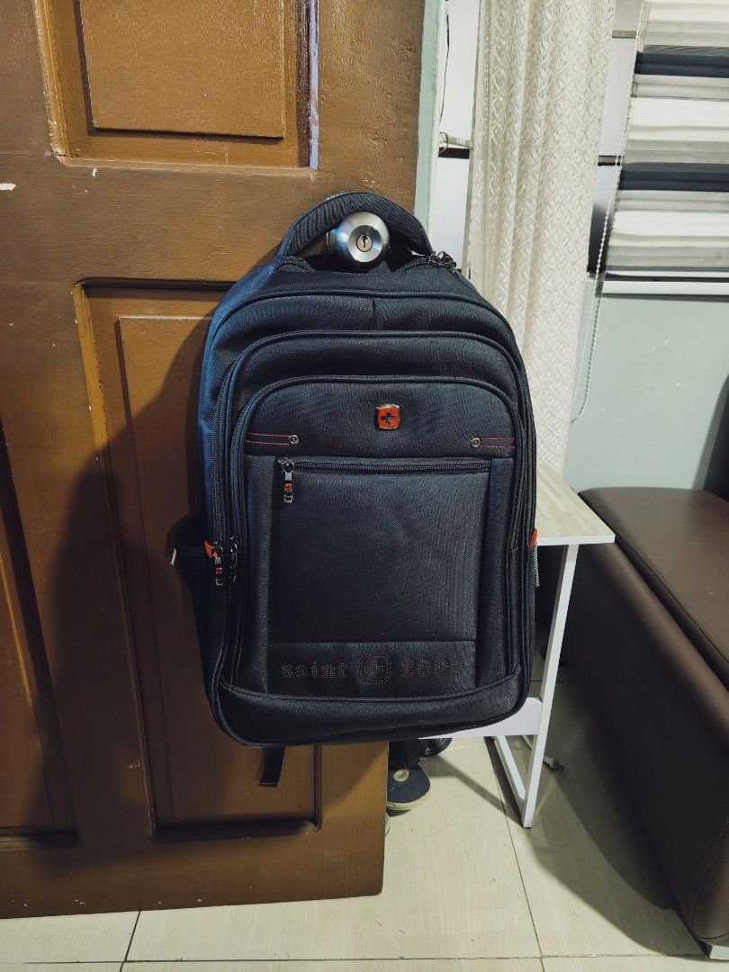 Saint 2009 Black Backpack/Bag (Category: Backpacks) located in Manila. Submitted by paul.c29cruz (Listing ID 1470994575, Image 1). Description: - Brand/Model: Saint 2009 black backpack - Storage: Multiple spacious zippered compartments (fits books, laptop, and daily gear) - Features: Sturdy top handle and trendy red accent stitching - Condition: Zippers work smoothly, solid and reliable everyday bag 100% ORIGINAL! Galing US! Parang bago pa! Black