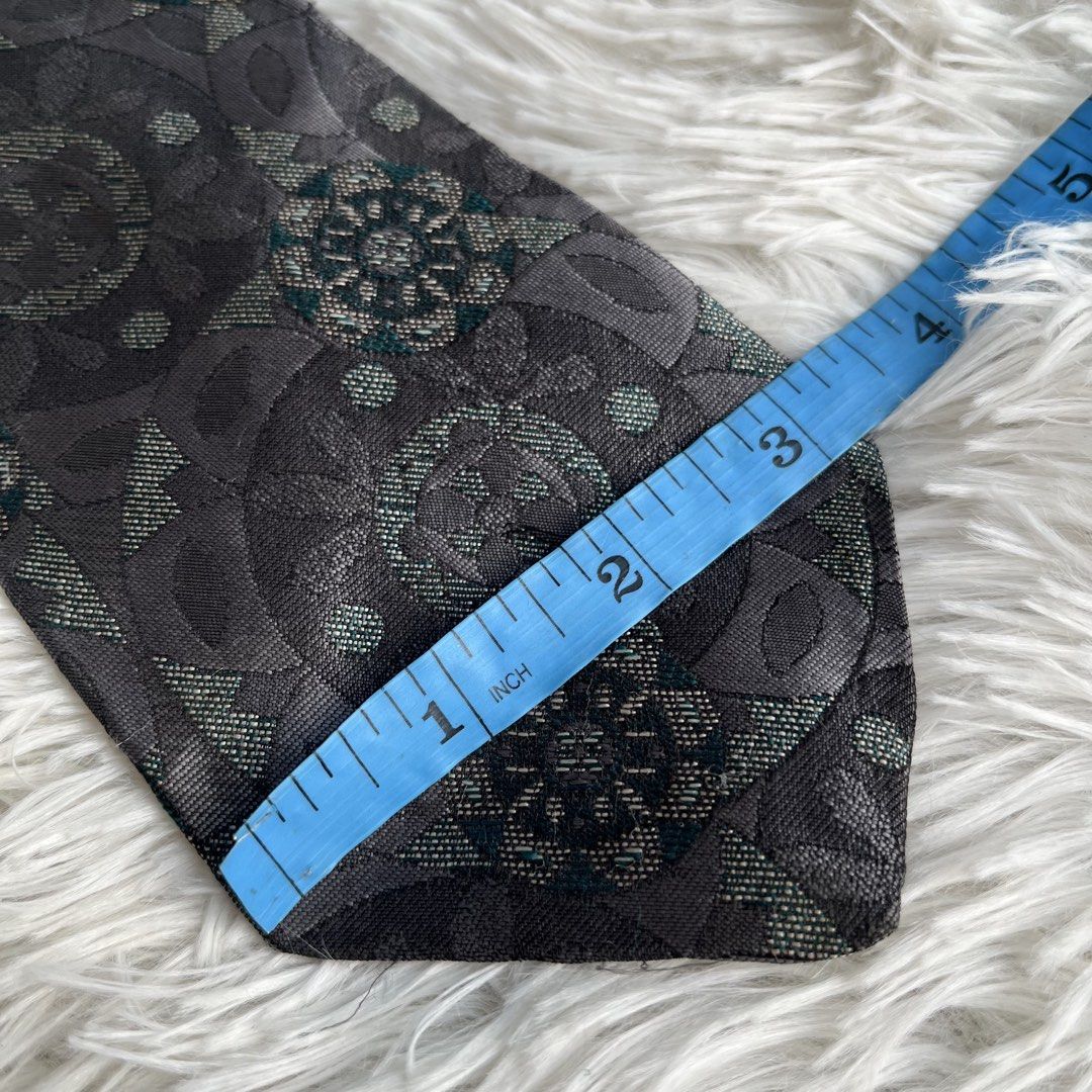 Salvatori Grey Geometric Floral Pattern Necktie (Category: Ties) located in Cuyapo. Submitted by Ashtyn.Pre.Loved (Listing ID 1471020147, Image 3). Description: - Brand: Salvatori - Color: Dark grey with green and silver accents - Design: Detailed geometric floral pattern - Width: Standard 3.75 inches at the widest point - Condition: Excellent, clean with no pulls or stains - Versatility: Ideal for business casual, office, or formal events.