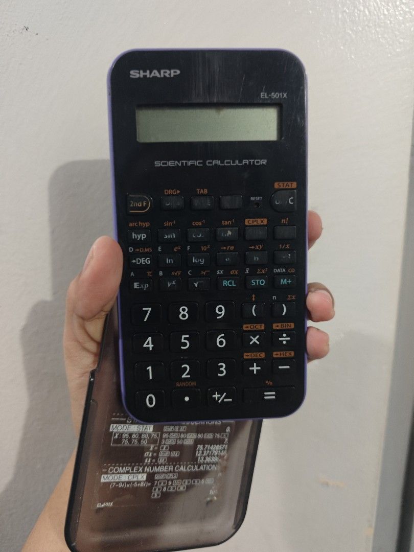 Scientific Calculator - Scical (Category: Office & Business Technology) located in Quezon City. Submitted by my_shoppee (Listing ID 1470949176, Image 1). Description: - Model: Sharp EL-501X Scientific Calculator - Color: Dark purple and black - Includes original protective sliding cover with handy calculation reference guides on the back - Screen is clear and intact with fully functioning buttons - Ideal for math, science, and engineering classes