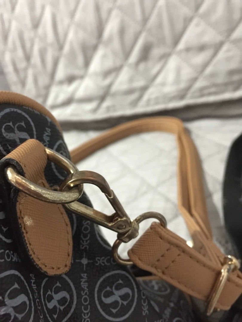 Secosana Black and Brown Shoulder Bag (Category: Shoulder Bags) located in Muntinlupa City. Submitted by prelovedbyanney (Listing ID 1471090245, Image 2). Description: FLAWS ARE SHOWN IN THE PICS (broken strap but i will give black extra strap - Brand: Secosana - Color: Classic black with stylish tan trim and gold-tone hardware - Design: Chic all-over logo pattern with a centered gold metal brand plaque - Compartments: Secure top zipper closure, 