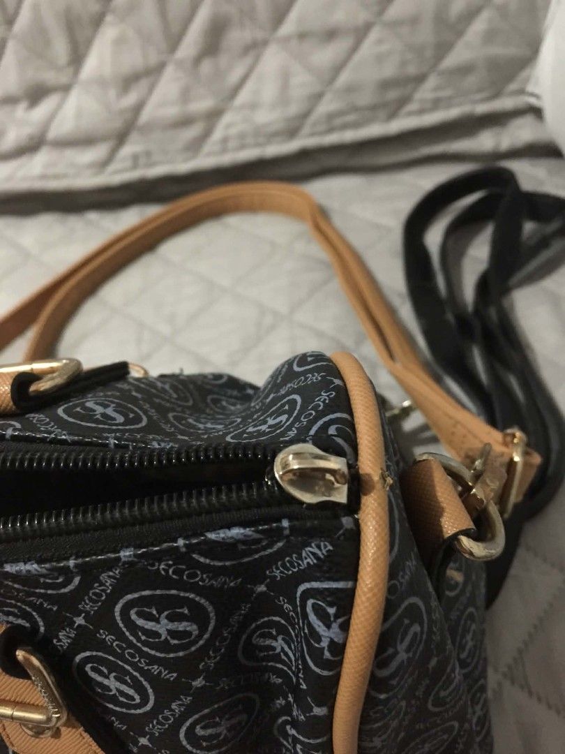 Secosana Black and Brown Shoulder Bag (Category: Shoulder Bags) located in Muntinlupa City. Submitted by prelovedbyanney (Listing ID 1471090245, Image 3). Description: FLAWS ARE SHOWN IN THE PICS (broken strap but i will give black extra strap - Brand: Secosana - Color: Classic black with stylish tan trim and gold-tone hardware - Design: Chic all-over logo pattern with a centered gold metal brand plaque - Compartments: Secure top zipper closure, 