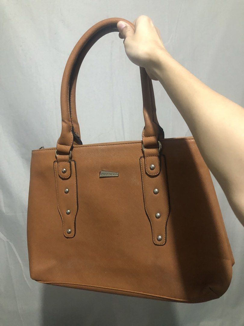 Secosana Tan Handbag and Blue Shoulder Bag Bundle (Category: Shoulder Bags) located in General Trias. Submitted by dmcwl (Listing ID 1471050395, Image 1). Description: PRELOVED BAGS FOR SALE! BUNDLED NA PO ITO FOR THE PRICE. - Bundle includes: Secosana tan structured handbag (with metal studs, logo plate, and zippered back pocket) and a blue bag (with tan straps and wooden tassel charm). - Condition: Clean interiors, minimal signs of wear on the 