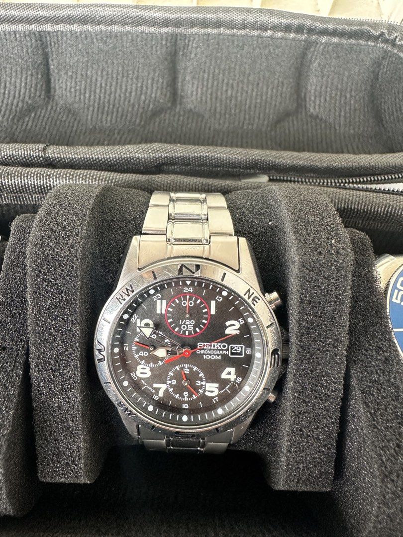 Seiko Chronograph 100M Men's Watch (Category: Men's Watches) located in Caloocan City. Submitted by alexandre12 (Listing ID 1470936702, Image 2). Description: - Brand: Seiko Chronograph Watch - Dial: Black dial with clear white numerals and date window at 3 o'clock - Features: Functional chronograph sub-dials and unique compass bezel - Material: Stainless steel case and bracelet with deployment clasp - Movement & Water Resistance: Reliable quartz