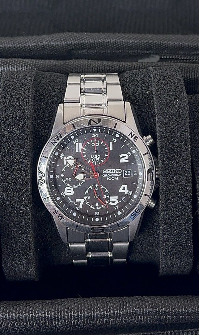 Seiko Chronograph 100M Men's Watch (Category: Men's Watches) located in Caloocan City. Submitted by alexandre12 (Listing ID 1470936702, Image 3). Description: - Brand: Seiko Chronograph Watch - Dial: Black dial with clear white numerals and date window at 3 o'clock - Features: Functional chronograph sub-dials and unique compass bezel - Material: Stainless steel case and bracelet with deployment clasp - Movement & Water Resistance: Reliable quartz