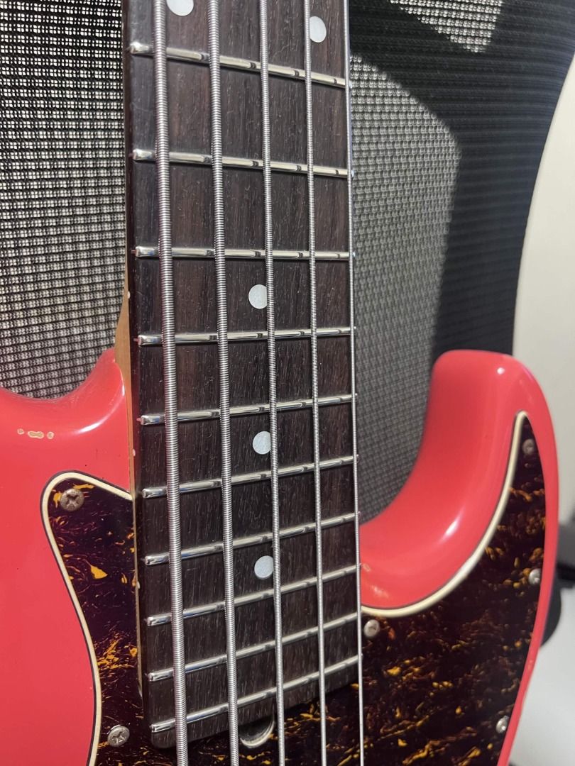 Semitone Model J Custom Relics 5-String Active/Passive Bass Guitar (Category: Musical Instruments) located in Carmona. Submitted by r.redone (Listing ID 1471059604, Image 3). Description: - Brand/Model: Custom relics 5-string electric bass by Semitone - Finish: Coral pink with heavy distressed relic wear and natural wood exposure - Construction: Solid body with a bolt-on maple neck and dark fretboard featuring dot markers - Electronics & Hardware