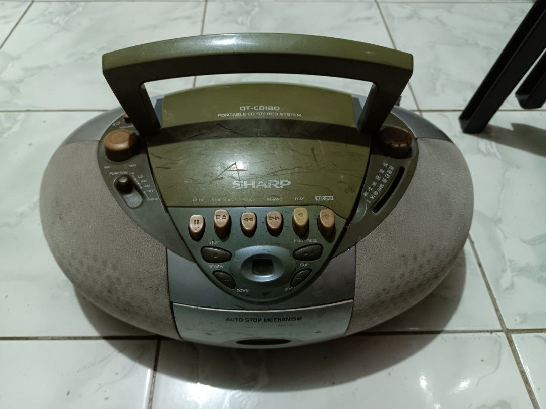 Sharp QT-CD180 Portable CD Stereo System (Category: Soundbars, Speakers & Amplifiers) located in Manila. Submitted by caaths_collection (Listing ID 1470968741, Image 1). Description: - Model: Sharp QT-CD180 portable stereo boombox - Color: Unique silver and olive green combo - Features: Plays CDs, cassettes, and AM/FM radio - Portability: Built-in top handle and side antenna - Condition: Shows normal scuffs and surface scratches from regular use.