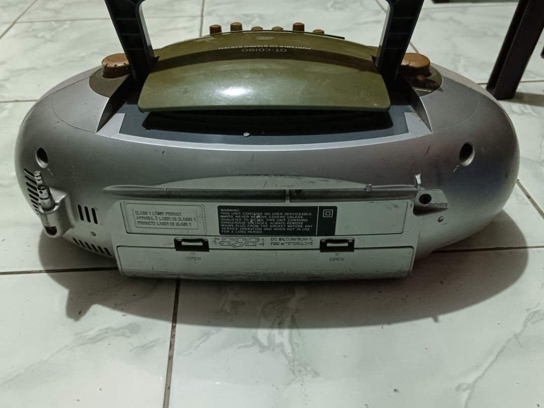 Sharp QT-CD180 Portable CD Stereo System (Category: Soundbars, Speakers & Amplifiers) located in Manila. Submitted by caaths_collection (Listing ID 1470968741, Image 3). Description: - Model: Sharp QT-CD180 portable stereo boombox - Color: Unique silver and olive green combo - Features: Plays CDs, cassettes, and AM/FM radio - Portability: Built-in top handle and side antenna - Condition: Shows normal scuffs and surface scratches from regular use.
