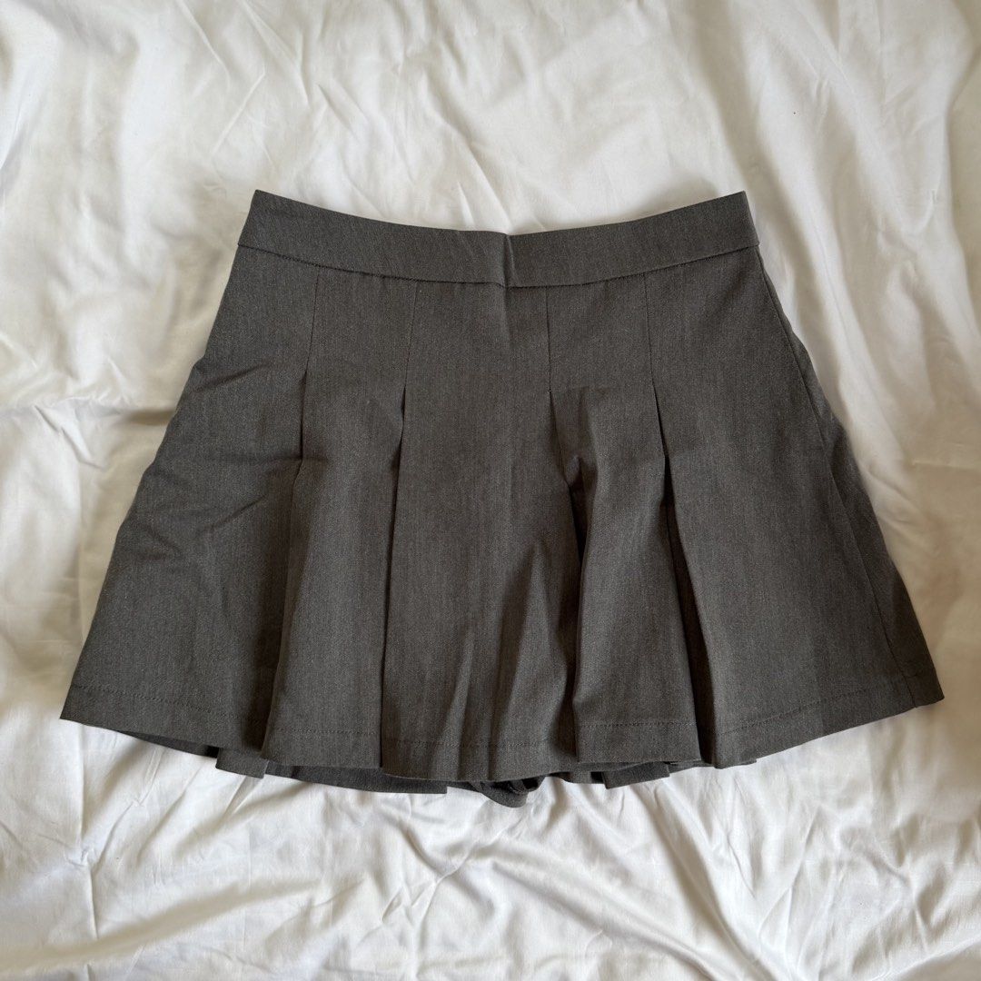 Shein Grey Pleated Skirt (Category: Skirts) located in Cavite. Submitted by kydeclutter (Listing ID 1470998299, Image 1). Description: - Style: Classic skater skirt with front pleats and structured waistband; has shorts inside - Versatile and easy to match with basic tops or jackets - Only worn once!.