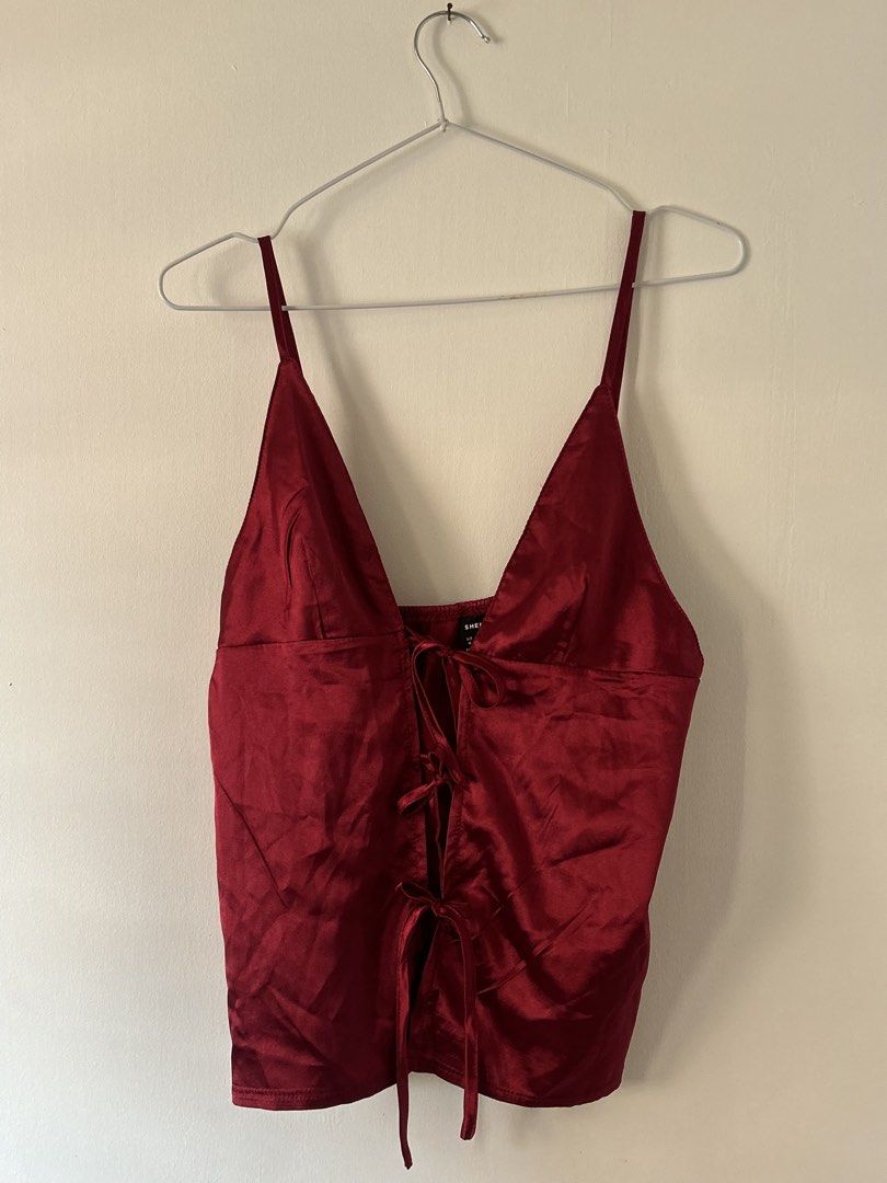 SHEIN Red Satin Tie Front Cami Top Size M (Category: Sleeveless) located in Batangas. Submitted by wearmegals (Listing ID 1470981528, Image 3). Description: - Brand: SHEIN - Size: M (EU 38, US 6) - Color: Vibrant Red - Material: Silky satin fabric - Design: Deep V-neckline, spaghetti straps, and trendy front tie-up closure with multiple ribbon bows.