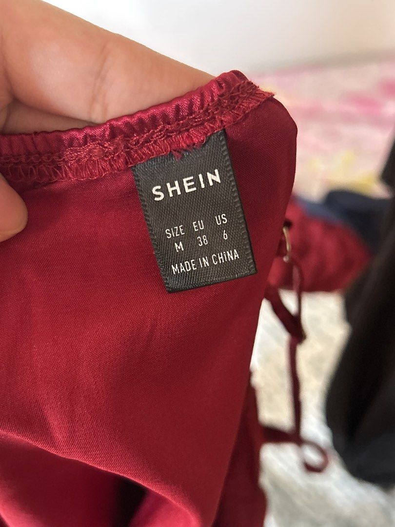 SHEIN Red Satin Tie Front Cami Top Size M (Category: Sleeveless) located in Batangas. Submitted by wearmegals (Listing ID 1470981528, Image 2). Description: - Brand: SHEIN - Size: M (EU 38, US 6) - Color: Vibrant Red - Material: Silky satin fabric - Design: Deep V-neckline, spaghetti straps, and trendy front tie-up closure with multiple ribbon bows.