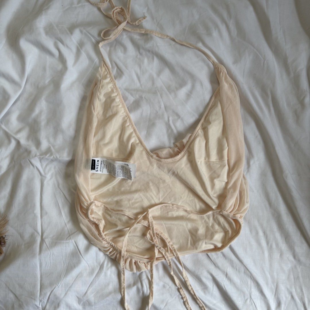 Shein Ruched Halter Top Beige (Category: Sleeveless) located in Cavite. Submitted by kydeclutter (Listing ID 1470983089, Image 2). Description: - Sheer mesh fabric with tons of gathering and ruching down the front. - Tie closure at the neck and back. - Super cute flowy drape. - Just a quick note: Color is more beige in real life than ww pics by model - Brand new, never worn out - RFS: Not my style.