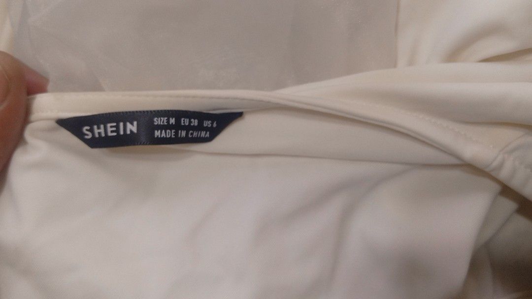 SHEIN White Puff Sleeve Tie Front Blouse Size M (Category: Blouses) located in Manila. Submitted by charlottej01596 (Listing ID 1470965076, Image 2). Description: - Brand: SHEIN - Size: M (EU 38, US 6) - Color: Clean White - Design: Deep V-neckline with multiple tie-front closures - Sleeves: Sheer mesh puff sleeves with ruffled cuffs - Fit: Cropped length, lightweight fabric - Condition: Excellent, well-maintained.