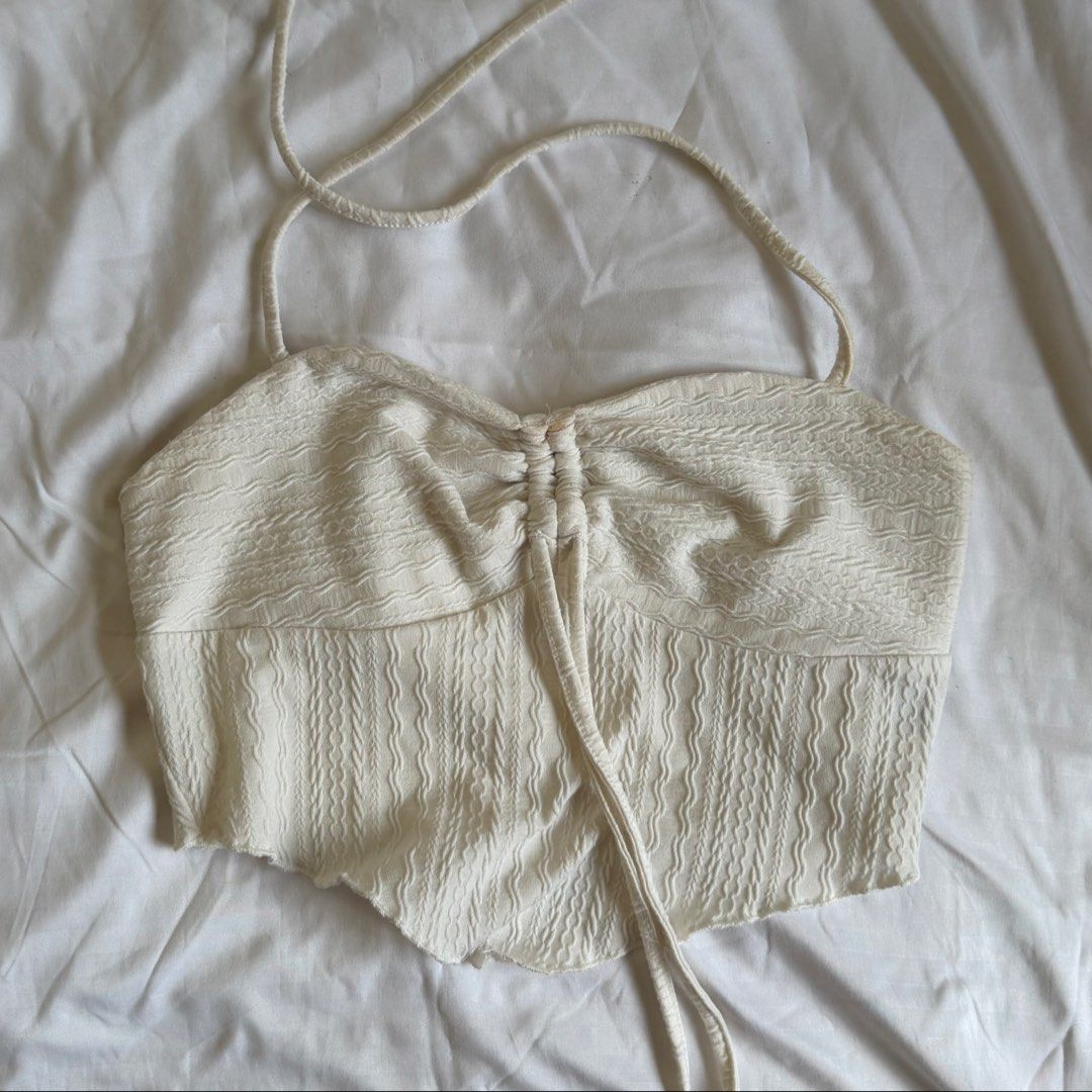 Shein White Textured Halter Top (Category: Sleeveless) located in Cavite. Submitted by kydeclutter (Listing ID 1470993063, Image 1). Description: - Style: Halter top with slim tie-neck straps - Details: Textured crinkled fabric, ruched bust with center drawstring tie - Material: Lightweight and breezy, perfect for summer - Condition: Has minor stains, a little bit off-white from repeated use.