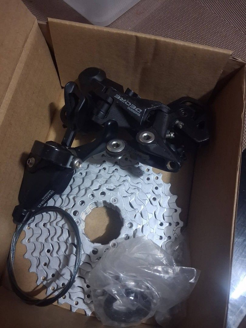 Shimano Deore Bicycle Derailleur and Cassette Bundle (Category: Bicycles) located in Manila. Submitted by elizer_tiger (Listing ID 1471052332, Image 2). Description: - Authentic Shimano Deore drivetrain bundle - Includes black rear derailleur, silver cassette sprocket, gear cable, and sealed small parts - Perfect for bike upgrades or repairs - Condition: Brand new in box - Meet-ups and nationwide shipping available via Carousell.