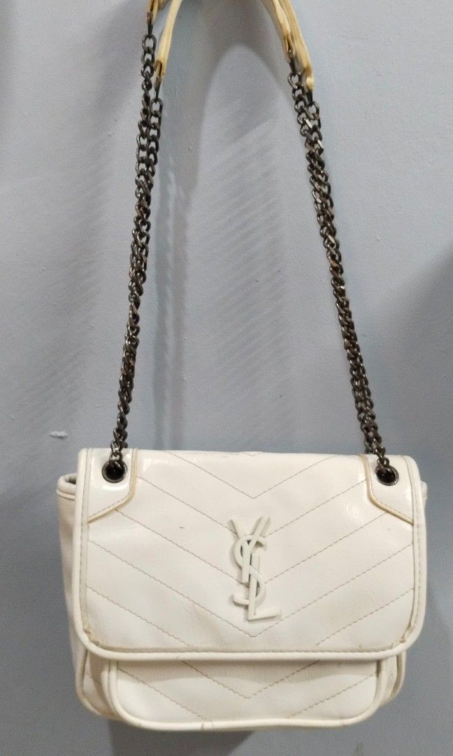 Sling / shoulder bag (Category: Cross-body Bags) located in Trece Martires City. Submitted by vherma (Listing ID 1470959940, Image 2). Description: white crinkled leather Saint Laurent Niki shoulder bag featuring chevron stitching, a tonal YSL logo plaque, and a chain-link strap..