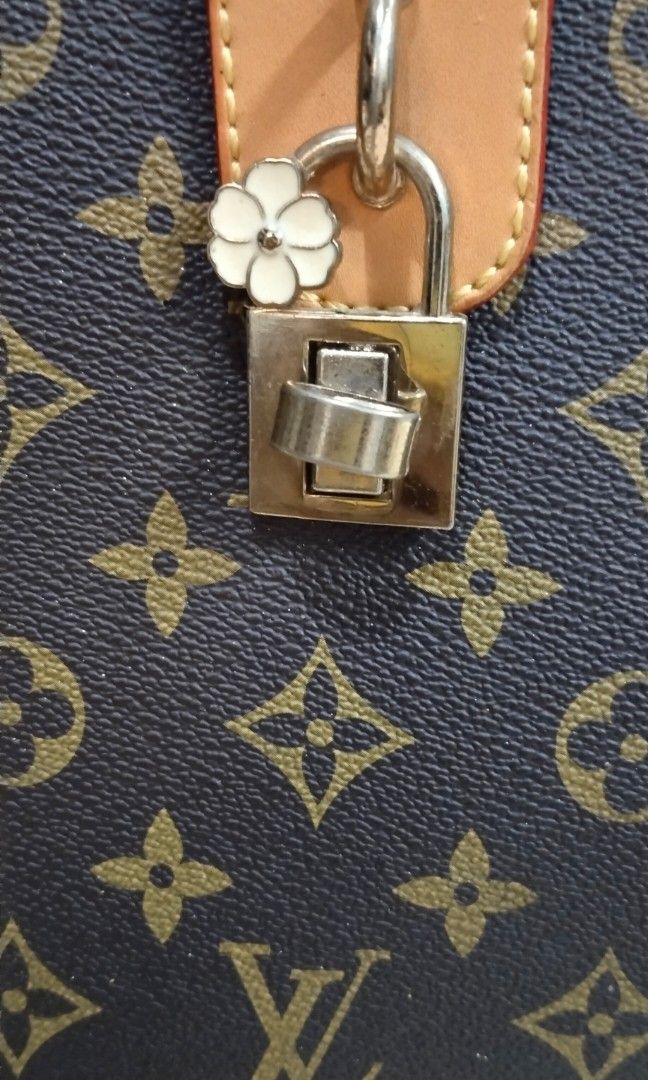 Sling bag (Category: Cross-body Bags) located in Trece Martires City. Submitted by vherma (Listing ID 1470963529, Image 3). Description: shoulder or crossbody handbag featuring a brown Monogram canvas exterior, studded/riveted detailing along the seams and vertical lines, a central tan leather tab, and a turn-lock or padlock closure with a flower accent..